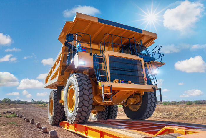Heavy load hauling, loading a mining truck in a trailer to transport